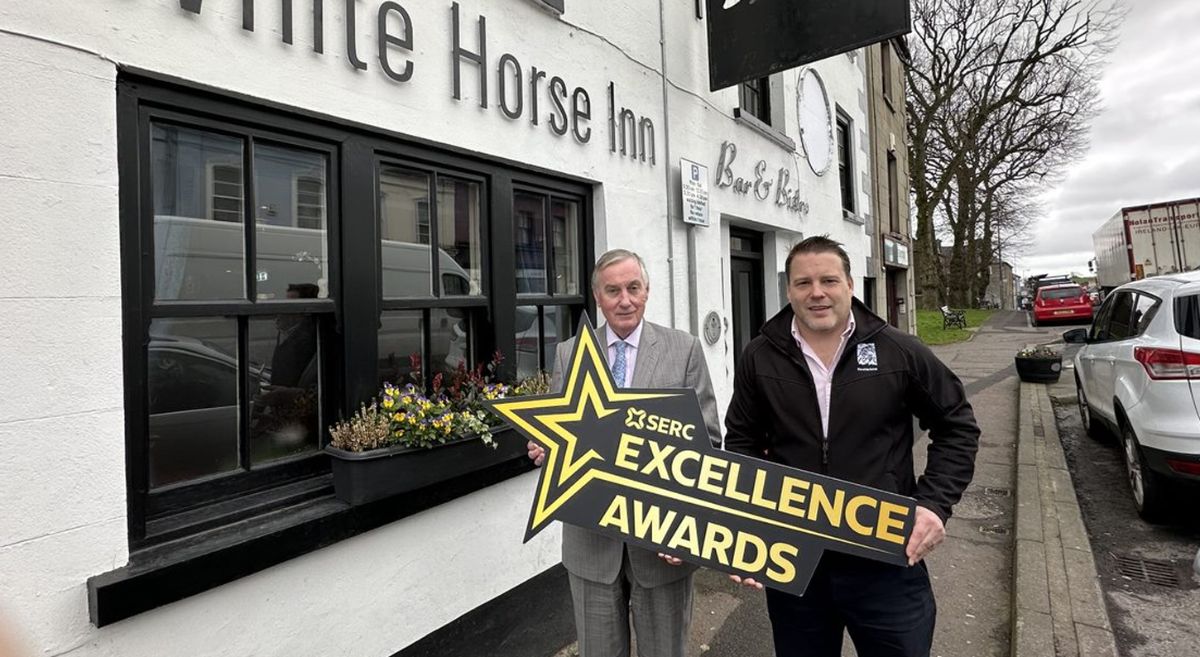 Image showing 2 men holding prop outside The White Horse Inn Saintfield